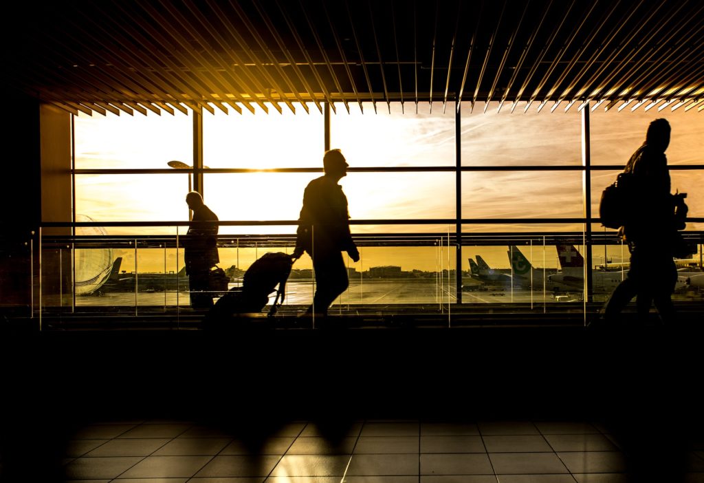 Corporate Travel - Man Walking Through Terminal - Prestige Limousines